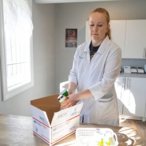 pharmacist packing medication to be mailed