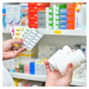 pharmacist holding pill packs and bottles